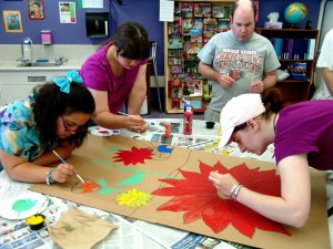 Painting backdrops for "The Wizard of Oz".