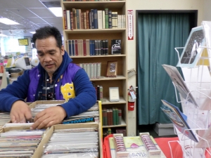 Freddy looks through comic books at a used book store.