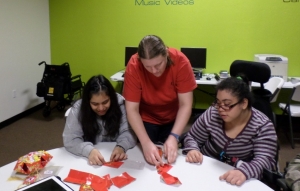 Karelia and Veronica get some help to make Chinese lanterns.