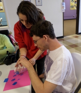 Hannah assists Matt with his bubble wrap painting.